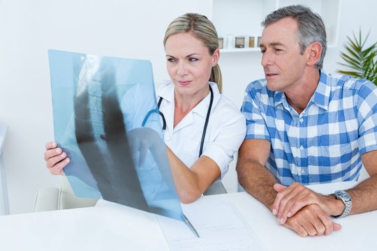 Doctor showing X rays to her patient 