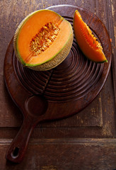 sliced melon on an old wooden board. cooking dessert.