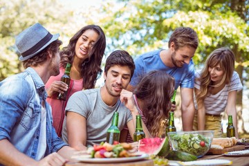 Happy friends in the park having lunch