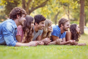 Fototapeta premium Friends lying and talking in the park
