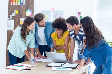 Group of young colleagues using laptop