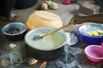 Zanzibar, native woman cook the food in a village of the interland