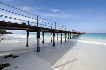 Zanzibar, a wharf with bungalows of an holiday village on the eastern coast