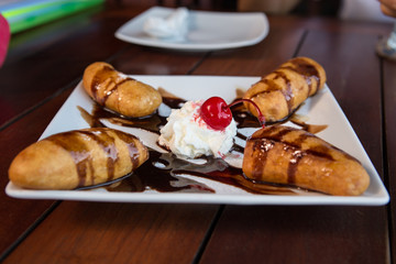 banana fritter with  whipcream and chocolate sauce