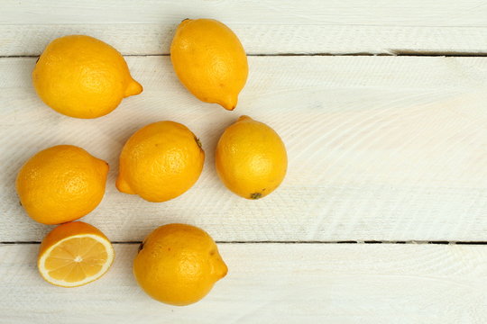 Fresh lemons on a wooden background