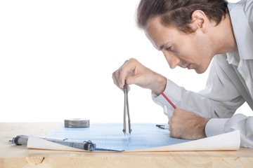 Engineer middle-aged white man examines blueprint