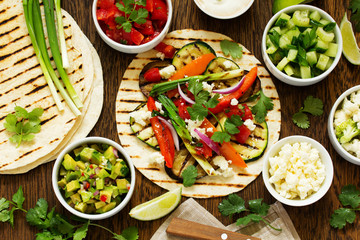 Vegetarian snack tacos with grilled vegetables and salsa.