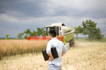 Businessman with combine harvester
