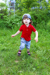 Cute little boy running in summer outdoors