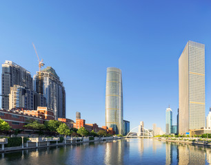 Obraz premium modern buildings in urban city at riverbank