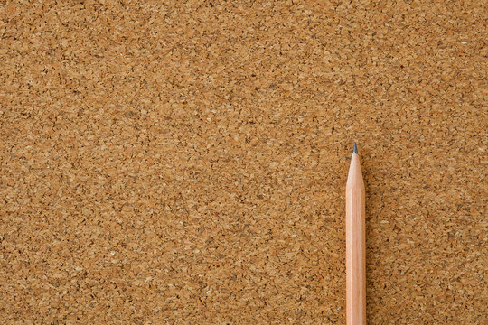 A Cork Board With A Pencil