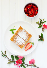 Pets (Belgian) waffles with strawberries and whipped cream.