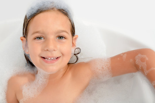 Adorable Toddler Girl Relaxing In Bathtub