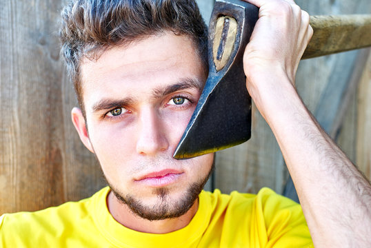 man shaves with an axe