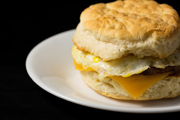 Breakfast sausage egg and cheese biscuit close view