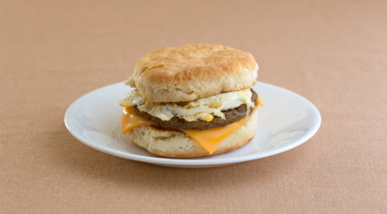 Breakfast sausage egg and cheese biscuit on plate