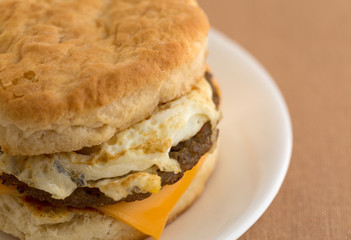 Close view of a breakfast sausage egg and cheese biscuit