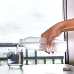 Fototapeta na wymiar Pouring water into a glass