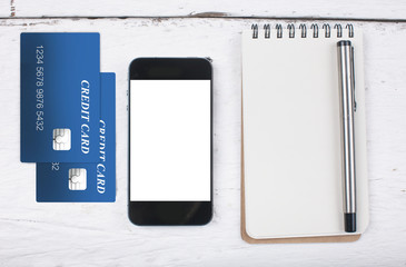 smart phone and note paper on wood table