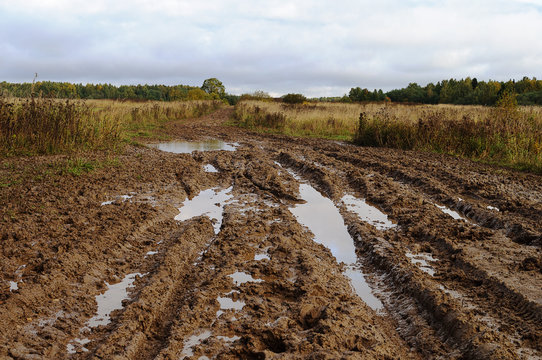 Fototapeta Messy rural dirt road after the rain