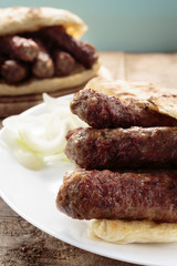 Cevapi (Cevapcici), Bosnian dish prepared on the barbecue and served with Lepinja bread. This dish is popular all over the Balkans, with tourists and locals.