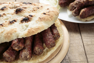 Cevapi (Cevapcici), Bosnian dish prepared on the barbecue and served with Lepinja bread. This dish is popular all over the Balkans, with tourists and locals.