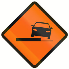 Temporary warning road sign in Indonesia: Uneven road