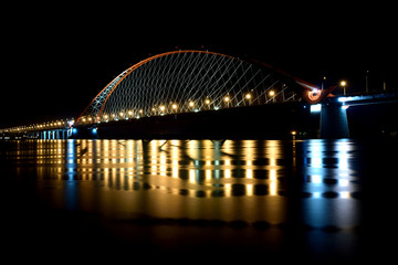 Fototapeta na wymiar Bridge with red arch in night light 