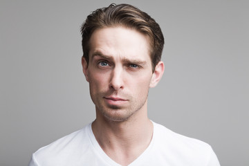 Doubting man in a white T-shirt