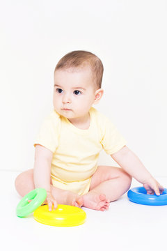 Beautiful baby playing with colorful toy
