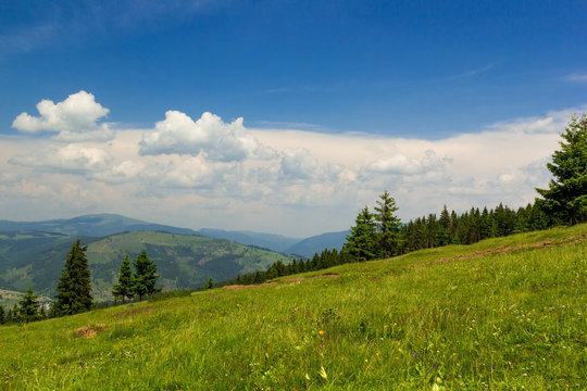 Mountain lanscape with blue cloudy sky on Vatra Dornei, Romania