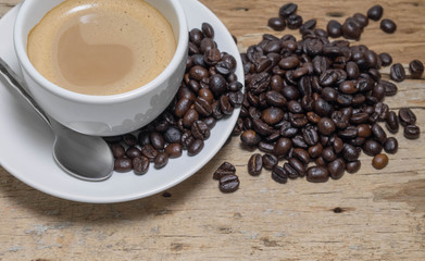 Coffee cup and saucer on a wooden table. Dark background.