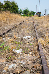 Vacant Rail way switch track with yellow die grass