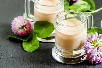 Coffee and Irish cream liqueur with flowers and clover shamrock