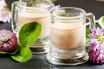 Coffee and Irish cream liqueur with flowers and clover shamrock