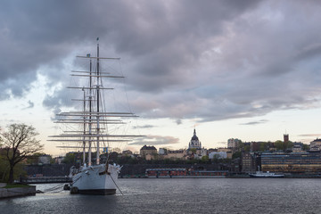 Fototapeta na wymiar Historical ship with sunset sky at the Old Town in Stockholm, Sweden