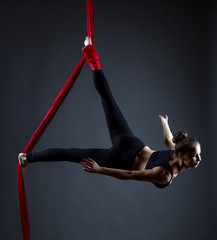 Studio shot of graceful female acrobat posing