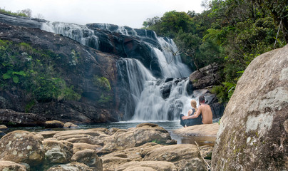 A group of young foreigners are watching the waterfall of Bakers Falls  in Sri Lanka