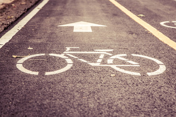 bicycle road sign painted on asphalt,vintage filter