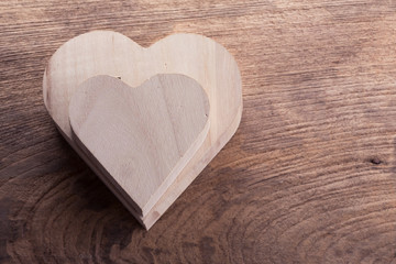 heart brown wood box on wood background, abstract love