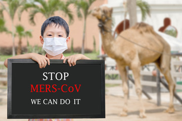  Asian boy wearing mask holding board with text 