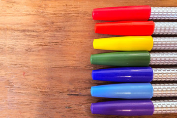Colorful Marker Pens in Rainbow Order on Wooden Table used as Template