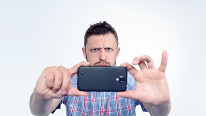 Bearded man photographed by smartphone