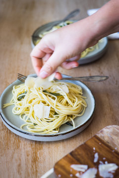 Spaghetti with Butter and Sage Being Served with Parmesan Shaves