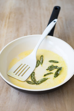 Fried Sage Leaves and Butter in a Ceramic Pan