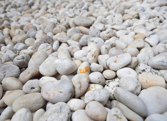 Colorful pebble stones texture on the beach.Focus on the front stone.