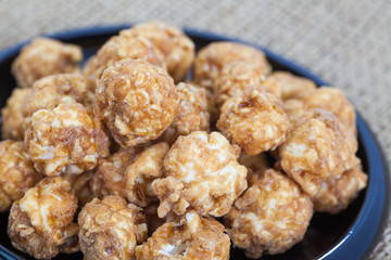 Almond and caramal popcorn on tablecloth background