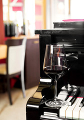 red wine glass and piano