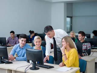 students with teacher  in computer lab classrom