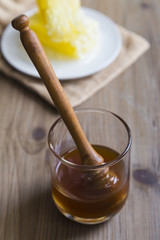 Honey dipper in a glass of honey